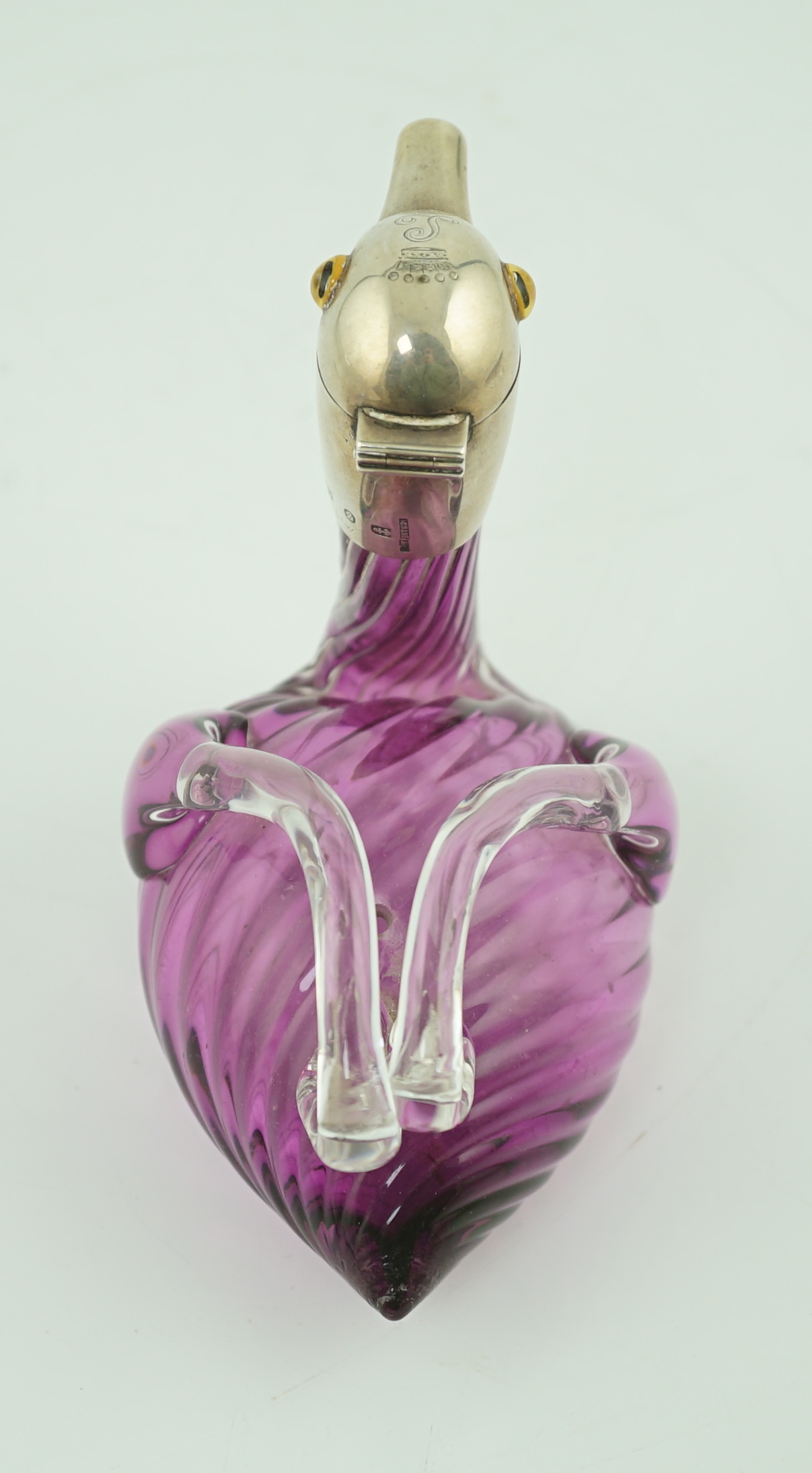 A late Victorian novelty silver mounted amethyst coloured glass liqueur jug, modelled as a duck, by Saunders & Shepherd, retailed by Thornhill